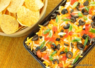 Tortilla Chip-throttling Insanity: Spicy Layered Bean Dip with Chorizo.